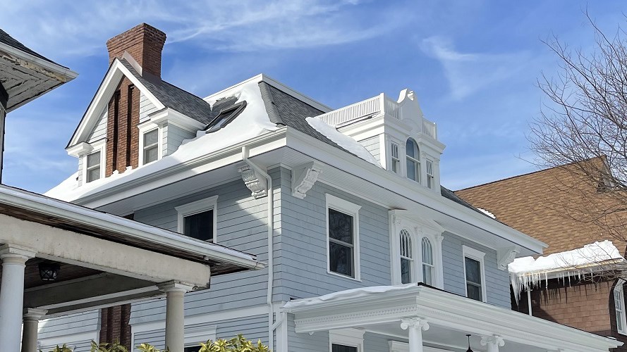 Restored Victorian wood-frame house with new pale blue siding